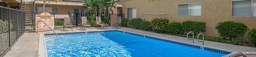 a large swimming pool in front of a building at Villa La Paz Apartments, California, 90706