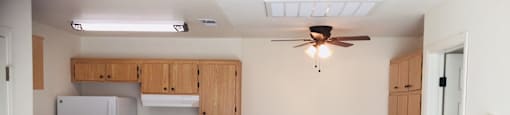 an empty kitchen with a counter and a ceiling fan at Victoria Springs, Riverside, CA 92504
