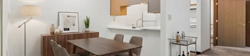 A modern dining room with a wooden table and chairs.