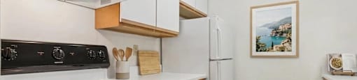 A kitchen with white appliances and wooden accents.