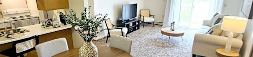 A living room with a dining table and chairs.