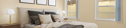 A bedroom with a bed, a ceiling fan, and three framed pictures on the wall.