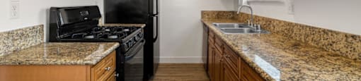 a kitchen with wooden cabinets and granite countertops