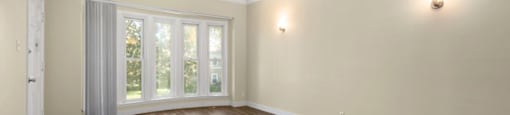 an empty living room with a large window