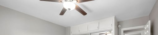 Van Nuys CA Apartments - Colonial Manor - Spacious Bedroom Area, Unfurnished, with Carpeted Floors, Sliding Mirror Closet, White Walls, Ceiling Fan, and Lights