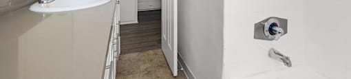 a bathroom with a sink and a door to a hallway