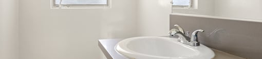 a small bathroom with a sink and a window