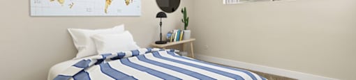 a bedroom with a bed and a map on the wall