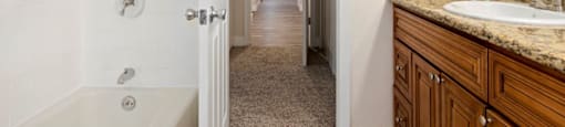 Studio Apartments in Encino CA - White Oak Terrace - Full Bathroom with Tub, Shower, and Wood-Style Cabinetry