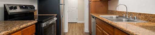 a kitchen with wooden cabinets and black appliances