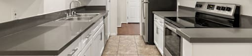 Two-Bedroom Apartments in Encino, CA - White Oak Terrace - Kitchen with Modern Stainless Steel Appliances and White Cabinetry with Chrome Hardware