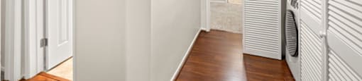 A hallway with a closet and washer and dryer.