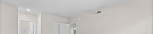 an empty living room with white walls and a carpeted floor