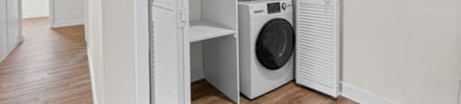 a laundry room with a washing machine in it