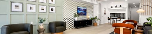 A living room with a wooden ceiling and a black and white checkered wall.