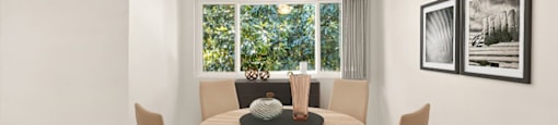 a dining room with a table and a ceiling fan