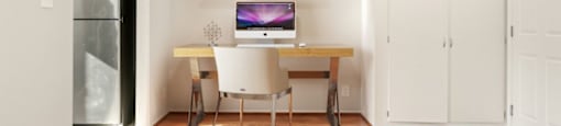 A room with a desk and a chair.