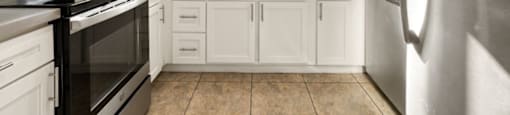 A kitchen with white cabinets and stainless steel appliances.
