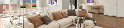 A modern living room with a white sofa and a glass table.