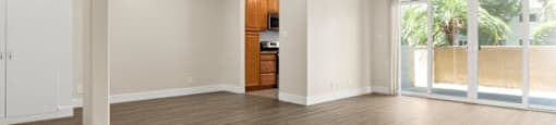 A room with wooden floors and a ceiling fan.
