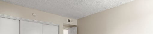 A room with a white door and a white closet.