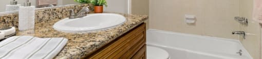 a bathroom with a sink and a toilet and a bath tub at Lombardi Apartments, Woodland Hills, California