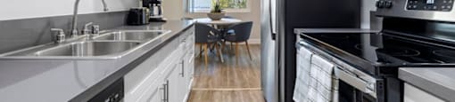 a kitchen with white cabinets and black appliances at Lombardi Apartments, Woodland Hills, CA, 91367