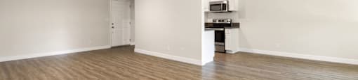 a living room and kitchen with wood flooring and a ceiling fan at Lombardi Apartments, California, 91367