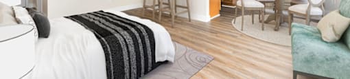 a bedroom with a bed and a kitchen with a table and chairs at Lombardi Apartments, Woodland Hills, CA, 91367