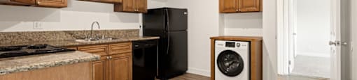 a kitchen with wooden cabinets and a washing machine