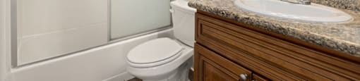 a bathroom with a sink toilet and shower
