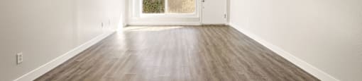 A room with wooden floors and white walls at The Reserve at Warner Center Apartments, California, 91367