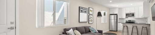 A modern living room with a grey couch and a white door.