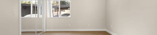 A room with wooden floors and a sliding glass door.