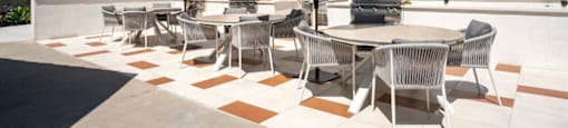 A patio with a table and chairs under umbrellas.