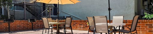 Pet-Friendly Apartments in Encino, CA- Brookside Terrace Apartments- Picnic Area with Circle Tables and Umbrellas