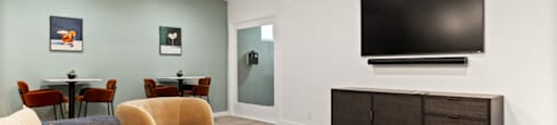 Studio Apartments in Encino, CA - Brookside Terrace - Clubhouse with Couches, Tables, Moutned TV, and Board Games on a White Coffee Table