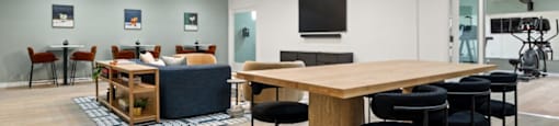 a living room and dining room with a table and chairs