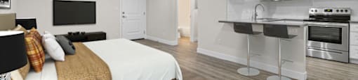 a bedroom with a bed and a kitchen