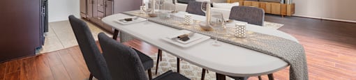 an open living room and dining room with a table and chairs