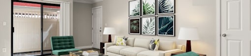 A living room with a green chair and a white couch.