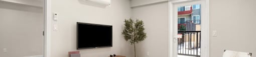 a living room with a tv and a table at Woodland Trio Apartments, North Hollywood, California