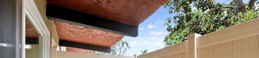 a porch with a fence and a blue sky in the background  at The Meadows at Westlake Village Apartments, CA, 91361