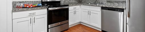 a kitchen with white cabinets and stainless steel appliances at The Meadows at Westlake Village Apartments,California, 91361