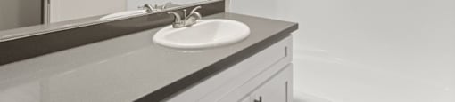 A bathroom with a sink and mirror.