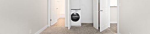 a bedroom with a washer and dryer at Woodland Trio Apartments, North Hollywood, CA