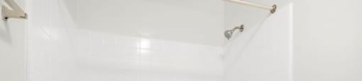 a white bath tub sitting next to a shower