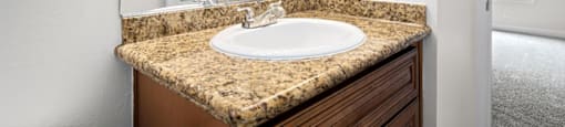 a bathroom with a sink and a mirror at Woodland Trio Apartments, California, 91601