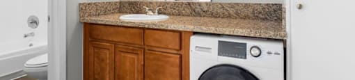a bathroom with a sink and a washer and dryer