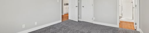wall to wall carpet, stylish decor, and white walls at The Reserve at Warner Center, California